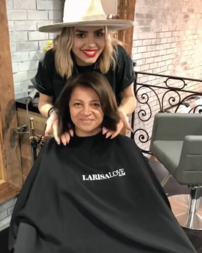 Larisa Love styling clients hair