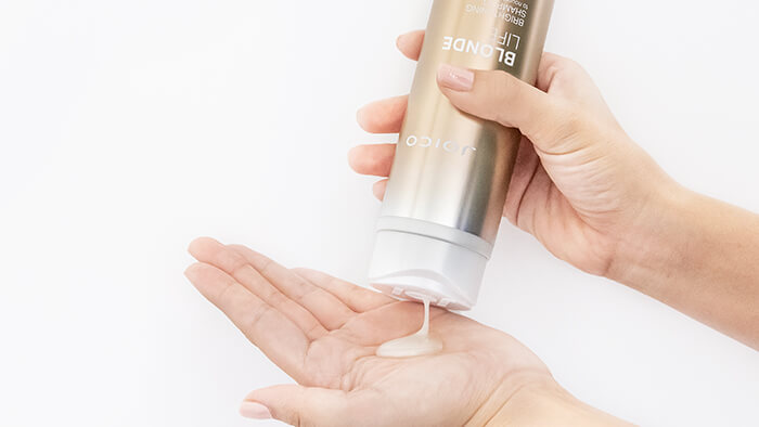 Blonde Life Shampoo coming out of bottle into hand