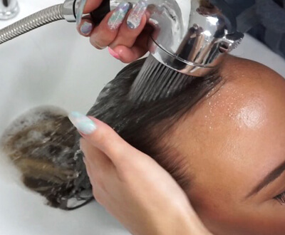 Womens Hair being shampooed in sink