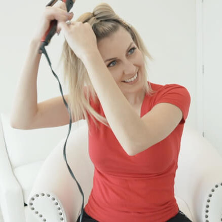 Women curling hair with curling iron