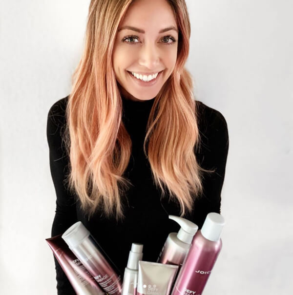 Hairstylist Jill Buck holding Defy Damage products