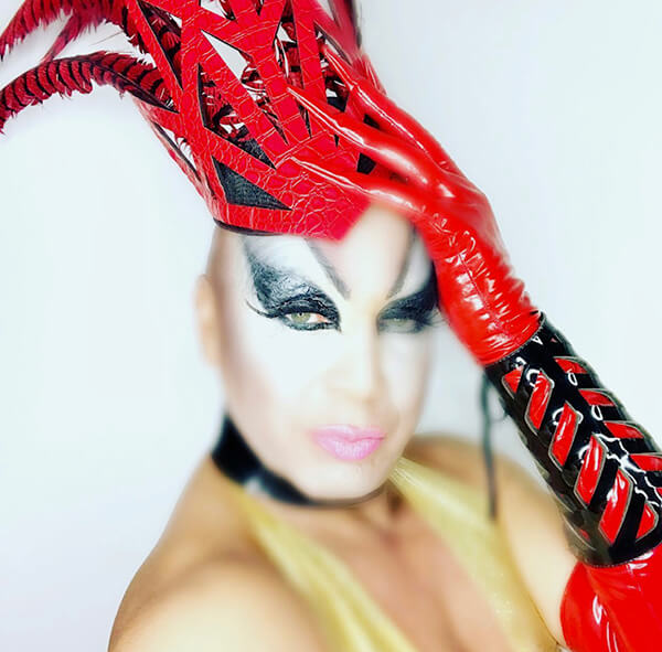 Drag Queen in vibrant red headers and gloves