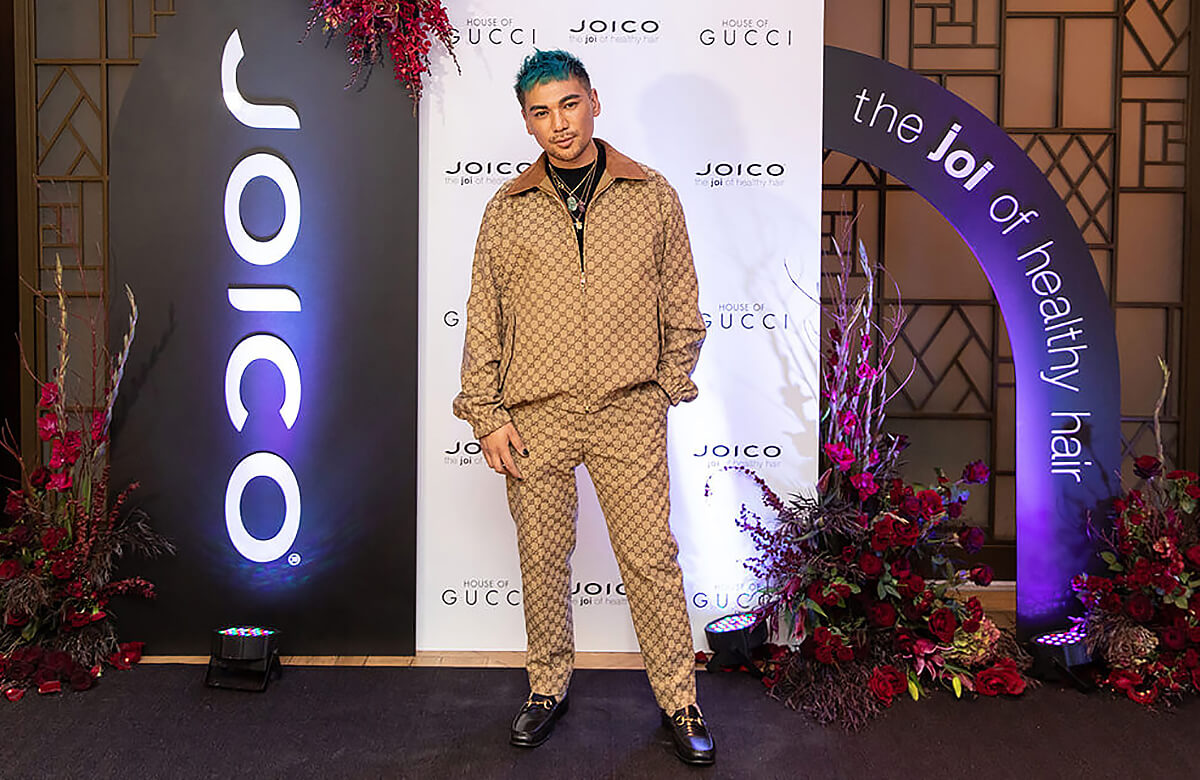Male posing for camera in Gucci suit